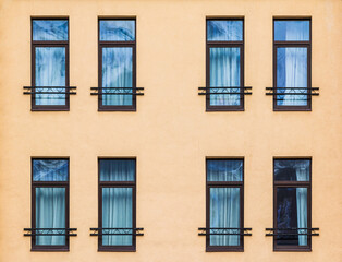 Fototapeta na wymiar Several windows in a row on the facade of the modern urban apartment building front view, Krasnaya Polyana, Sochi, Krasnodar Krai, Russia 