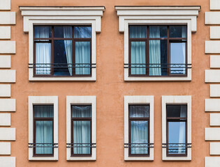 Fototapeta na wymiar Several windows in a row on the facade of the modern urban apartment building front view, Krasnaya Polyana, Sochi, Krasnodar Krai, Russia 