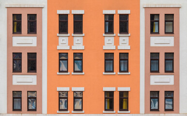 Many windows in a row on the facade of the modern urban apartment building front view, Krasnaya Polyana, Sochi, Krasnodar Krai, Russia
