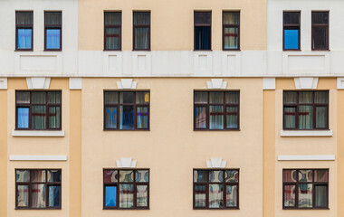 Fototapeta premium Many windows in a row on the facade of the modern urban apartment building front view, Krasnaya Polyana, Sochi, Krasnodar Krai, Russia 