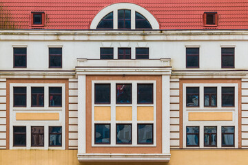 Many windows in a row on the facade of the modern urban apartment building front view, Krasnaya Polyana, Sochi, Krasnodar Krai, Russia
