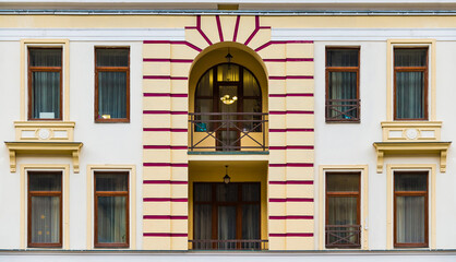 Two balconies and many windows in a row on the facade of the modern urban apartment building front view, Krasnaya Polyana, Sochi, Krasnodar Krai, Russia  © dr_verner