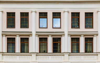 Fototapeta na wymiar Many windows in a row on the facade of the modern urban apartment building front view, Krasnaya Polyana, Sochi, Krasnodar Krai, Russia 
