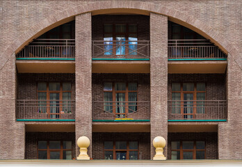 Many balconies and windows in a row on the facade of the modern urban apartment building front view, Krasnaya Polyana, Sochi, Krasnodar Krai, Russia
