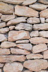 Background or wall of stones. Old masonry mural or wall of stones of different sizes. Texture or graphic resource of a stone wall.