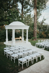 Beautiful setting for outdoors wedding ceremony. Wedding arch with flowers.