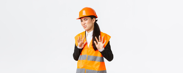 Reluctant and displeased asian female engineer refuse listen, showing stop, prohibit gesture,...