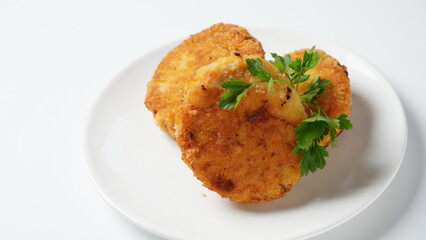 Plate with chicken cutlets. Fried juicy  cutlets on a white plate garnished with parsley