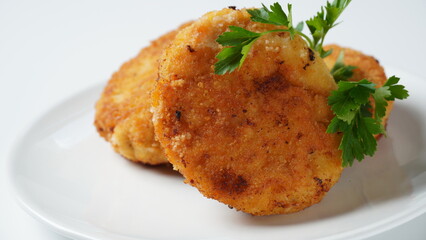 Plate with chicken cutlets. Fried juicy  cutlets on a white plate garnished with parsley
