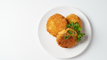 Plate with chicken cutlets. Fried juicy  cutlets on a white plate garnished with parsley