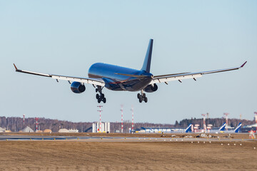 Landing of the passenger plane at sunset.