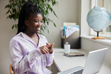 Teenage Girl Having Conversation Using Sign Language On Laptop At Home