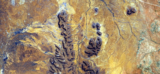 abstract landscape photo of the deserts of Africa from the air emulating the shapes and colors of plants after battle, Genre: Abstract naturalism, from the abstract to the figurative