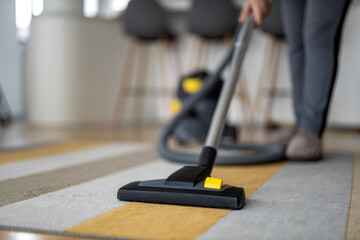 Woman using vacuum cleaner at home