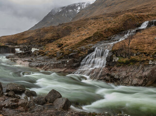 Fototapeta na wymiar Stunning Winter landscape image of River Etive and Skyfall Etive Waterfalls in Scottish Highlands