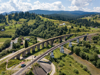 Old railway bridge in the mountains. Ukrainian Carpathians. Aerial drone view.