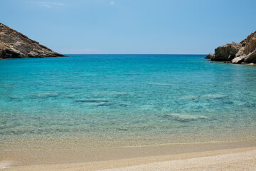 Fototapeta na wymiar Panoramic view of the stunning turquoise beach of Tripiti in Ios Greece