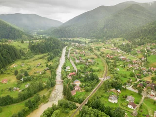 Foto op Canvas Settlement in the mountains of the Ukrainian Carpathians. Aerial drone view. © Sergey