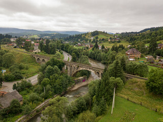 Old railway bridge in the mountains. Ukrainian Carpathians. Aerial drone view.