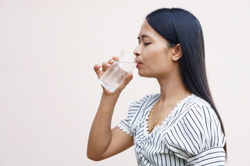Asian woman drinking water for good health