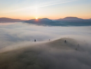 Sunrise over the fog in the Ukrainian Carpathians. Aerial drone view.