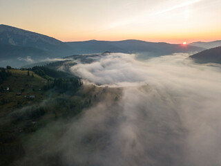Morning fog in the Ukrainian Carpathians. Aerial drone view.