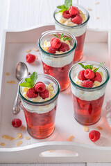 Homemade red jelly made of berries and whipped cream.