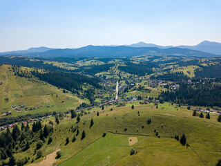 Green mountains of Ukrainian Carpathians in summer. Sunny clear day. Aerial drone view.