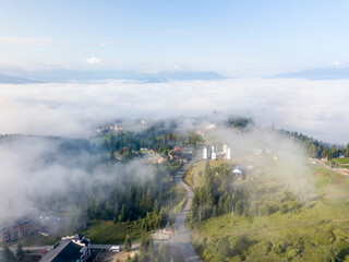 Fototapeta na wymiar Mountain settlement in the Ukrainian Carpathians in the morning mist. Aerial drone view.