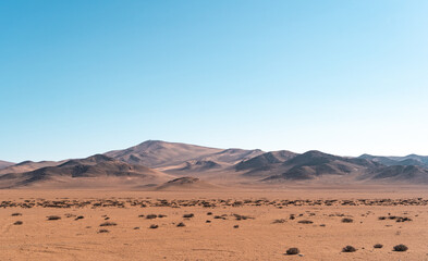Fototapeta na wymiar Panoramic horizontal shot of mountains and dunes of the Atacama Desert, Caldera, Chile.