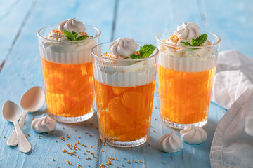 Fresh and sweet orange jelly with small mandarins and cream.