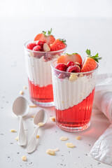 Delicious and creamy red jelly as summer dessert with cream.