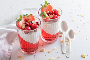 Homemade and tasty red jelly with whipped cream and berries.