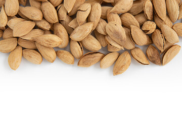 heap of unpeeled almonds isolated on white background