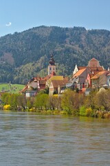 Fototapeta na wymiar Frohnleiten, - small town above Mur river in Styria, Austria. View at Parish church, town and river Mur. Famous travel destination.