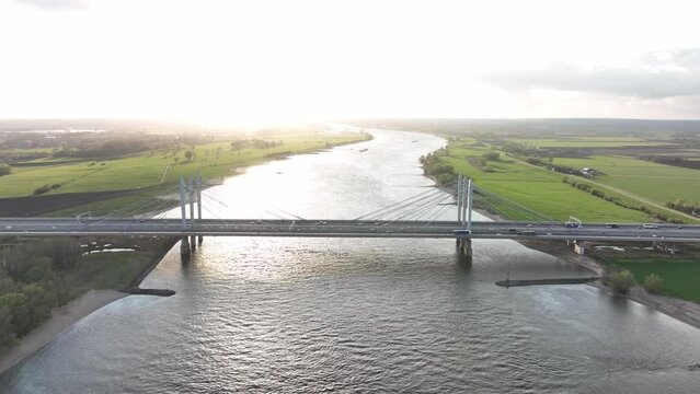 Tacitusbrug bij Ewijk modern suspension bridge crossing the river Waal near Nijmegen, the Netherlands Holland Europe. Valburg and Ewijk. Traffic highway over waterway. Holland.