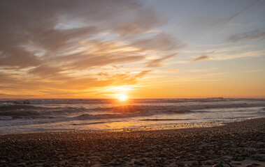 Horizontal shot of a colorful sunset at Concón beach with lens flare, Chile