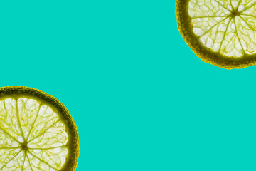 Lime slices isolated on green  background.