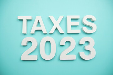Taxes 2023 alphabet letters on blue background