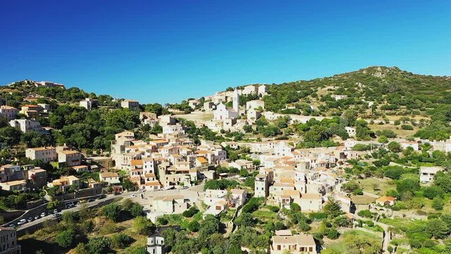 The city of Corbara in the middle of the arid and green mountains, in Europe, in France, in Corsica, by the Mediterranean Sea, in summer, on a sunny day.