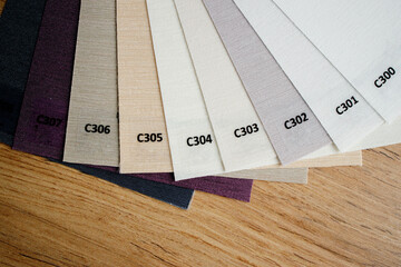 Samples of textured fabrics of different colors for the manufacture of fabric blinds for sun protection. Palette to choose from