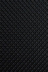 Close up of black synthetic textured fabric with a rhombus pattern used to make blinds. Template design or polyester material abstract background.