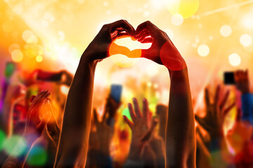 Crowd fans hand silhouettes at rock pop concert, party, event. Abstract blurred background. Many...