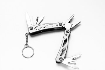 Multi-Tools Spring-Action Pliers, Knife, Screw Driver, Scissors and Other Indispensable Tools on iSolated White Background.