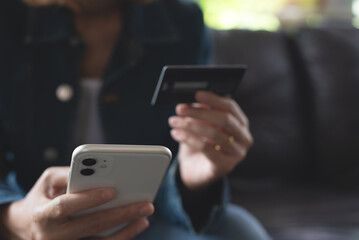 Young woman hands holding credit card, using smart mobile phone for digital banking, internet payment, online shopping via mobile banking app, financial technology, E-commerce