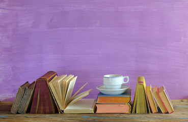 home office,education,business,concept with  row of books and cup of coffee, purple background,...