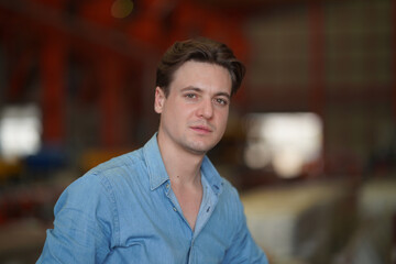 Fototapeta premium Portrait of a young handsome confident on casual outfit standing outdoor.