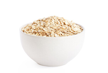 raw oat flakes in light beige plate isolated on white background