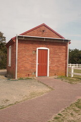 Fototapeta na wymiar Orange and Red Brick Utility Shed for Hatteras Lighthouse