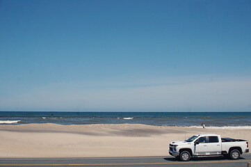 White Pickup Truck on Road Next to Ocean, Dunes, Water, Sunny © Monica